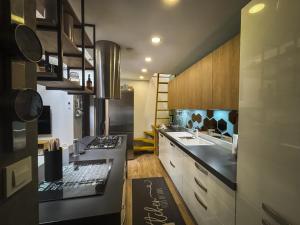 a kitchen with a sink and a counter top at Celia Center Celje Apartment in Celje