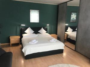 a bedroom with a bed with two towels on it at Girasole Orselina in Orselina