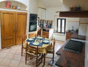 a kitchen with a table and chairs in a kitchen at Occitanie in Bazus