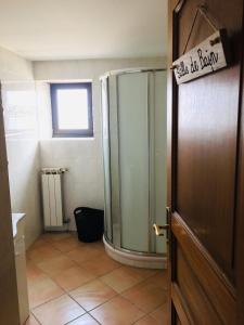 a bathroom with a shower and a sign on the door at Occitanie in Bazus