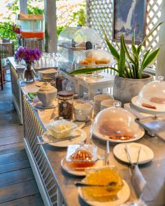 a buffet with plates of food on a table at Tartaruga Beach Unawatuna in Unawatuna