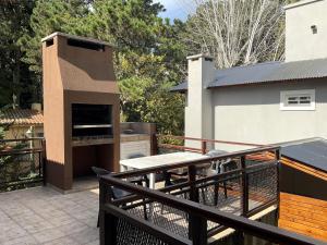 a patio with a barbecue on a deck at Pax Costa del Este - Pax Suites in Costa del Este
