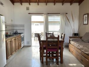 a kitchen and dining room with a table and a couch at Pax Costa del Este - Pax Suites in Costa del Este