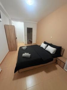 a bedroom with a large bed with two towels on it at Luxury Apartments Miranda in Ohrid