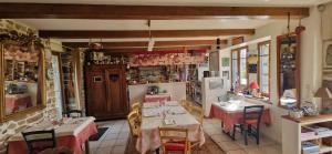 a restaurant with tables and chairs in a room at Auberge De Bel Air in Brélès