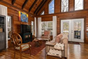 a living room with a couch and a tv at Lakin' it Easy! - Powder Horn Mountain in Powderhorn Mountain