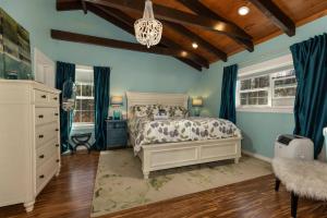 a bedroom with a bed and blue walls and wooden ceilings at Lakin' it Easy! - Powder Horn Mountain in Powderhorn Mountain +53 photos