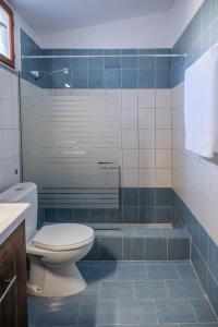 a bathroom with a toilet and a bath tub at White Lotus in Próti +7 photos