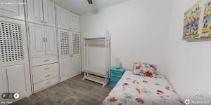 a white bedroom with a bed and a closet at Best area and ocean view in Cruz de Huanacaxtle +8 photos