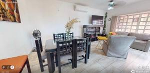 a living room with a table and chairs and a couch at Best area and ocean view in Cruz de Huanacaxtle