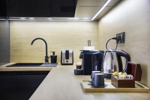 a kitchen with a sink and a coffee maker at Calmora apartment Optická WiFi Klimatizace Balkon Nespresso in Komárov