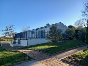 a house with a balcony on the side of it at Le Chalet de Pratviel - proche Albi in Puygouzon-et-Montsalvy