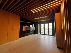 an empty room with wooden ceilings and a hallway with windows at Focsani Studio Residence 3 in Focşani
