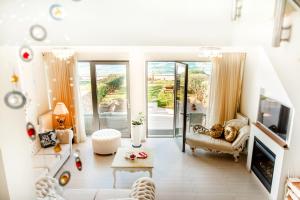 a living room with a couch and a tv at Sea View Beachfront Villa Maria in Gouves