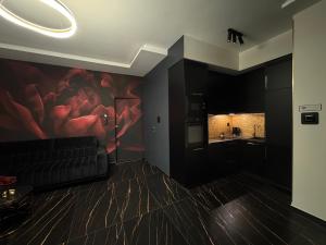 a living room with a couch and a painting on the wall at Moon Luxury Apartment - Jacuzzi & Sauna in Wałbrzych