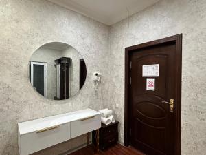 a bathroom with a sink and a mirror at Marvarid Hotel in Ghijduwon +21 photos
