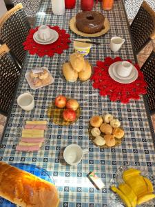 a table with a bunch of food on it at Suíte Freitas Piri in Pirenópolis