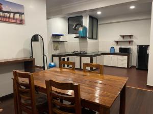 a kitchen with a wooden table and chairs at Mughal Empire Hotel Pvt ltd in Pātan