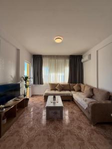 a living room with a couch and a coffee table at Heming-way Hotel in Durrës