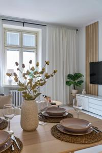 a living room with a table with plates and wine glasses at Beautiful and Spacious Studio in Helsinki in Helsinki