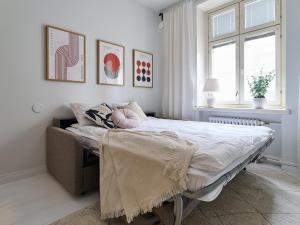 a bedroom with a bed and a window at Beautiful and Spacious Studio in Helsinki in Helsinki