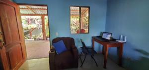 a room with a desk with a laptop and a chair at Calala House in Balgue