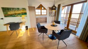 a living room with a table and chairs at Hotel und Gutsgaststätte Rappenhof in Weinsberg