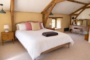 a bedroom with a large white bed in a room at Woolladon Hall in Meeth
