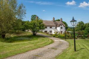a house with a street light next to a road at Woolladon Hall in Meeth