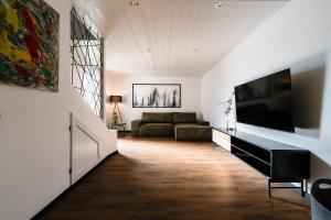 a living room with a couch and a flat screen tv at Seethal in Laufen