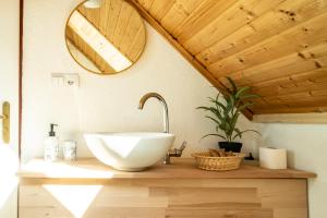 a bathroom with a bowl sink and a mirror at Pension Harmony in Bešeňová +76 photos