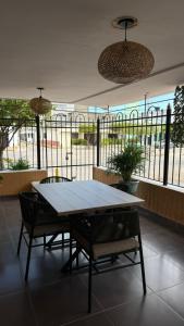 a table and chairs in a room with a balcony at Casa Marina Hotel Boutique in Ríohacha
