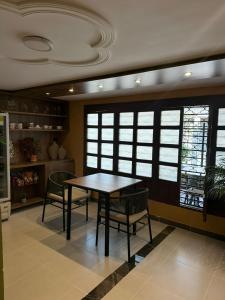 a dining room with a table and chairs and windows at Casa Marina Hotel Boutique in Ríohacha +21 photos