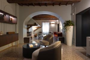 a living room with a couch and chairs and a table at Villa Clementi Boutique Hotel in Cave