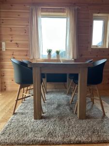 a dining room with a wooden table and chairs at Deer Cottage in Sylte +16 photos