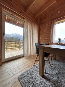 a dining room with a table and a large window at Deer Cottage in Sylte
