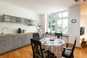 a kitchen and dining room with a table and chairs at Ferienwohnung Fehmarn in Fehmarn