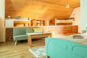 a living room with a couch and bunk beds at Pension Harmony in Bešeňová