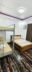 a room with two bunk beds in it at Amor apartment in Coron