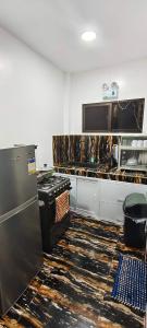 a kitchen with a stove and a counter top at Amor apartment in Coron