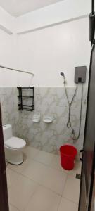 a bathroom with a toilet and a shower at Amor apartment in Coron