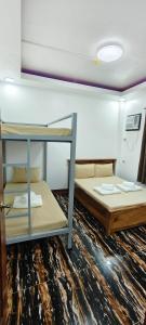 two bunk beds in a room with a ceiling at Amor apartment in Coron +3 photos