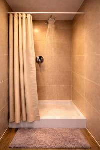 a bathroom with a shower with a shower curtain at Hofgut Stefan - BIO, Bodenständig, Bodensee in Uhldingen-Mühlhofen