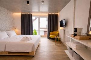 a hotel room with a bed and a tv at Hofgut Stefan - BIO, Bodenständig, Bodensee in Uhldingen-Mühlhofen