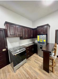 a kitchen with wooden cabinets and a counter top at Arrendamientos portillo in Puerto Barrios
