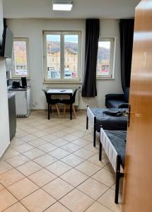 a living room with two beds and a table at Apartment-Herrlingen in Blaustein
