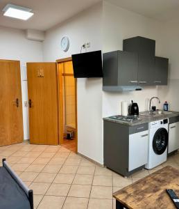 a kitchen with a stove and a washing machine at Apartment-Herrlingen in Blaustein +1 photo