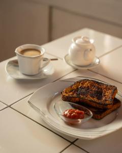 a plate of toast and a cup of coffee on a table at Rwanda African Art Museum in Nyabisindu