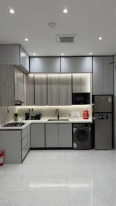 a large kitchen with stainless steel appliances and cabinets at شقه ثلاث غرف بحي المروه in Jeddah