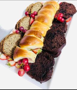 a plate of food with bread and fruit on it at 33OnPangolin B&B in Nelspruit